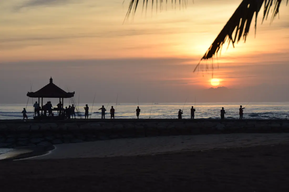 A palm-lined beach and calm turquoise water in the Nusa Dua resort area of Bali